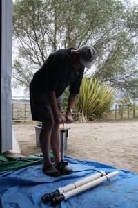 Stan ZL2ST pressurizing the spud gun to shoot a line over the trees for an antenna halyard.