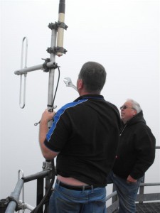 Laurie ZL2TC changing the clamp on one of the '725 antennas at Taraponui. The picture was taken from the ground and zoomed up, hence the white conditions as the cloud swirled around.
